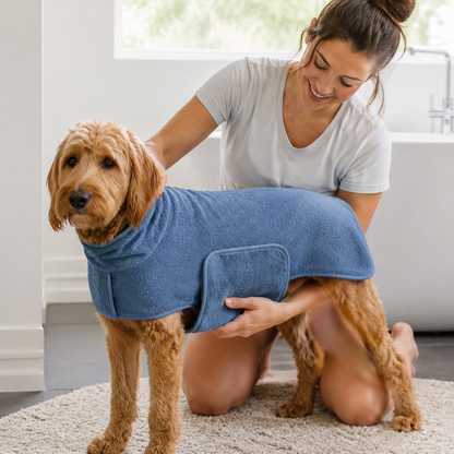 Pet owner securing the blue DryWrap bathrobe around a dog
