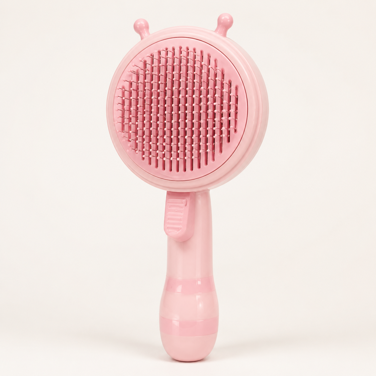 Pink ShedLess Duo pet grooming brush on a clean studio background
